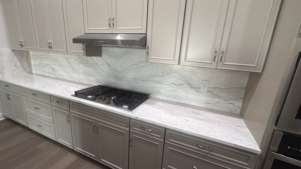 Bookmatched Stone Kitchen with Full-Height Backsplash
